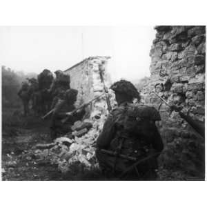 British Troops Wary of German Snipers Move Cautiously Behind a Ruined 