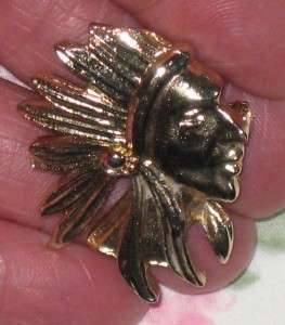 THIS INDIAN HEAD PIN IS GOLDTONE & MEASURES APPROX. 1 X 1 3/8 IN. & IS 
