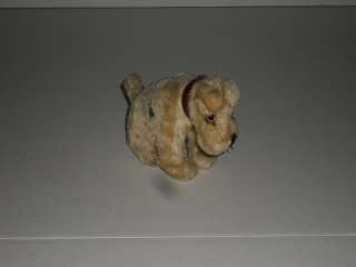 up for auction is a stuffed toy dog in a sitting position that appears 